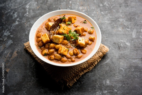 Fototapeta Chole Paneer curry made using boiled chickpea with cottage cheese with spices. Popular North Indian recipe. served in a bowl or serving pan. Selective focus