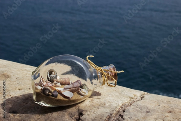 Obraz Glass bottle with sand and shells inside