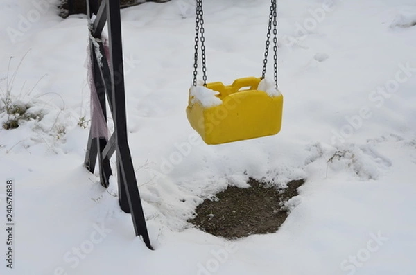 Obraz an empty swing under the snow