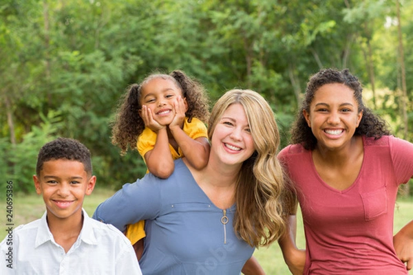Fototapeta Portarit of a happy mixed race family smiling
