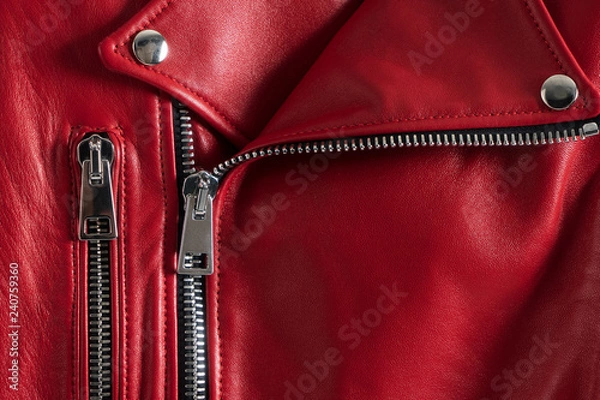 Fototapeta Red leather women's jacket with metallic zipper and buttons. Modern fashionable clothes. Detailed closeup view.