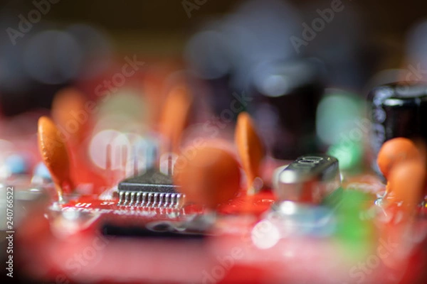 Fototapeta Close up (Macro) of Printed Circuit Board PCB embedded components (inductors, resistors, capacitors, diodes, microchips, transistor) with short depth of view