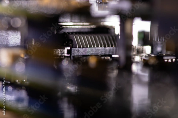 Fototapeta Close up (Macro) of Printed Circuit Board PCB embedded components (inductors, resistors, capacitors, diodes, microchips, transistor) with short depth of view.