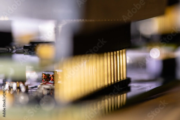 Fototapeta Close up (Macro) of Printed Circuit Board PCB embedded components (inductors, resistors, capacitors, diodes, microchips, transistor) with short depth of view.