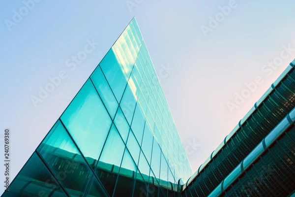 Fototapeta modern building triangular shape. Futuristic office on a clear sky background