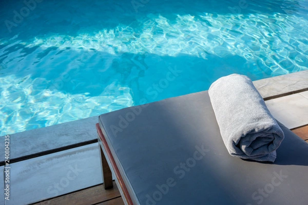 Obraz Towel on relaxing pool bed beside swimming pool.
