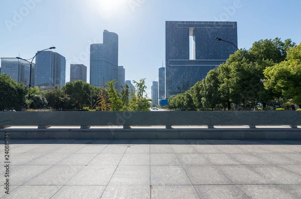 Fototapeta Panoramic skyline and buildings with empty concrete square floor，Qianjiang New Town，hangzhou,china