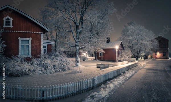 Obraz Public park with cozy cafe place and snow covered trees at winter evening in Finland. Cafe place is open only in summertime.