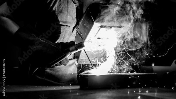 Fototapeta welder worker at work at a metalworking company