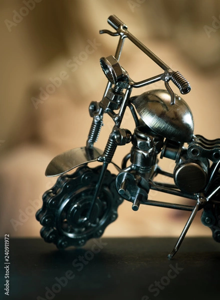 Fototapeta Close up (Macro) of Handmade metal toy motorcycle/motorbike made out of scrap metal pieces with short depth of view