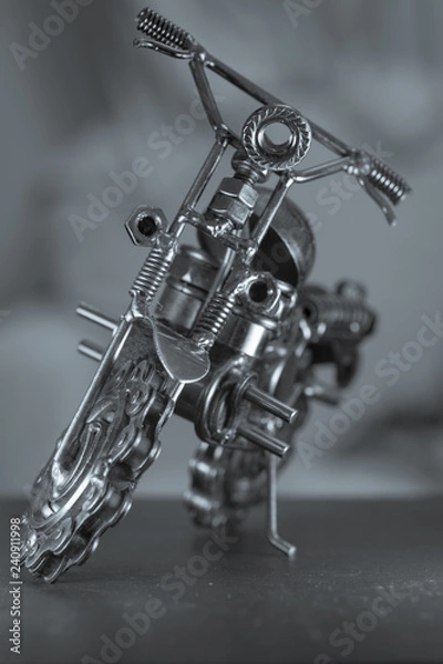 Fototapeta Close up (Macro) of Handmade metal toy motorcycle/motorbike made out of scrap metal pieces with short depth of view