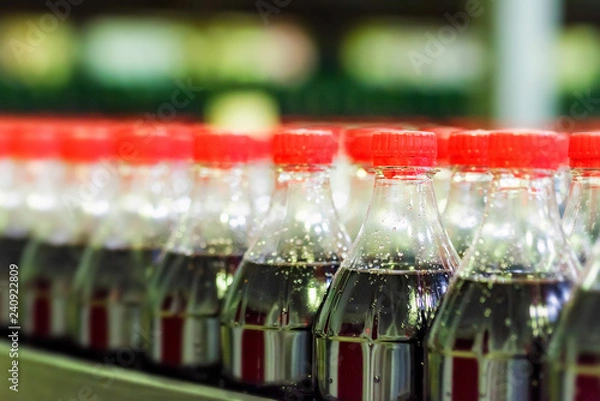 Fototapeta Soft drink bottling line at a factory