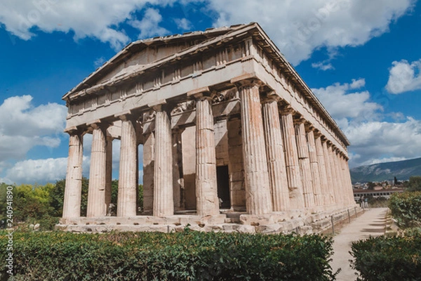 Fototapeta Temple of Hephaestus in Agora close-up, Athens, Greece. It is one of the main landmarks of Athens. Front view of the ancient Greek Temple of Hephaestus in summer. Historical sunny postcard of Athens.