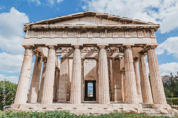 Fototapeta Temple of Hephaestus in Agora close-up, Athens, Greece. It is one of the main landmarks of Athens. Front view of the ancient Greek Temple of Hephaestus in summer. Historical sunny postcard of Athens.