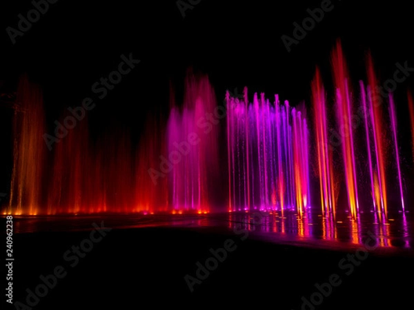Fototapeta  colored decorative dancing water jet led light fountain show at night