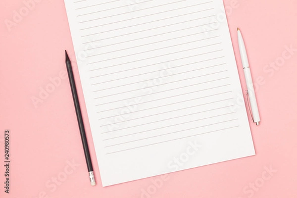 Obraz Blank page in a line with black pencil and white pen. Plans and goals for the year. Freelancer workplace concept. Top view with copy space for input the text. Flat lay, colored pink background.
