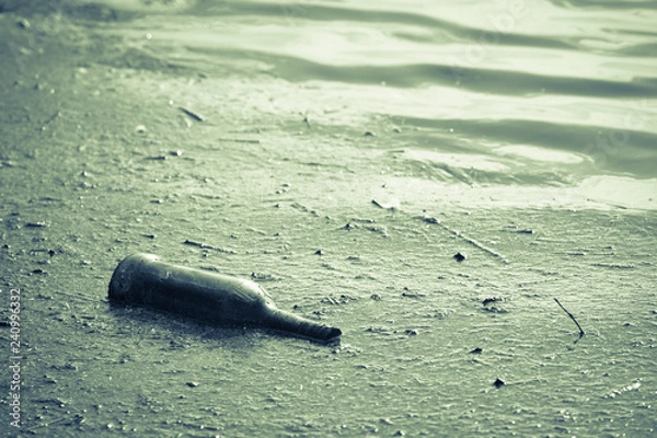 Obraz Pollution of the environment, bottle waste in water.
