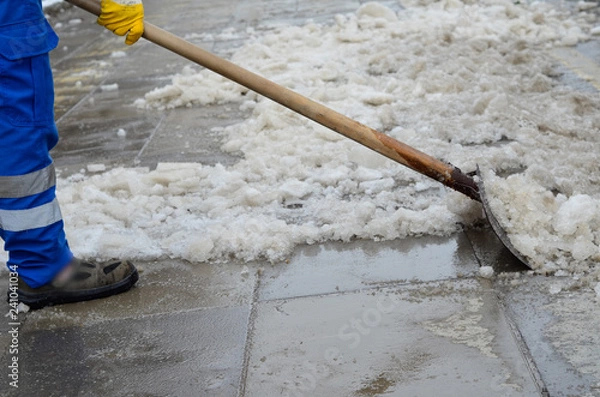 Obraz attendant shoveling snow on sidewalk