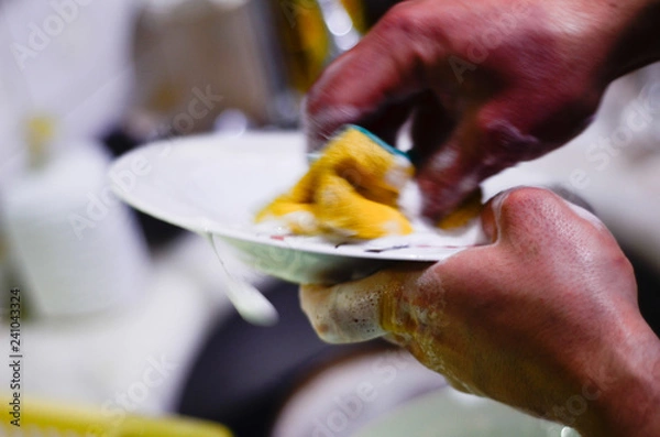 Obraz a dirty plate is hand washed 