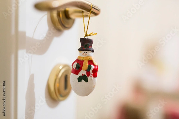 Fototapeta horizontal image with detail of a nice Christmas decoration hanging from a wardrobe key