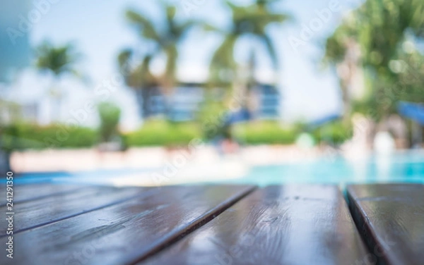 Obraz Blur wooden table on pool background,