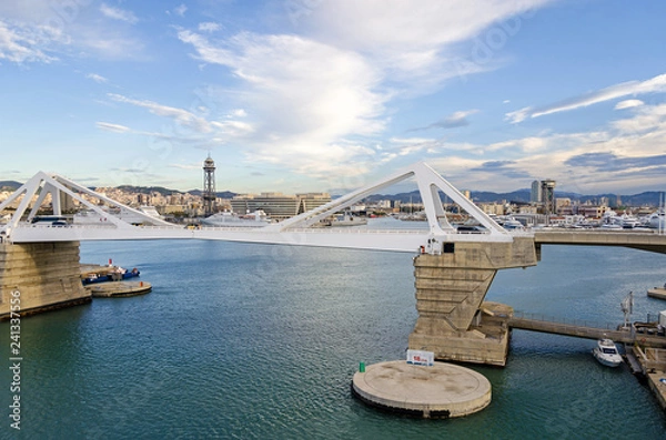 Fototapeta  Port Vell with its bridge Porta d'Europa and aerial tramway towers in Barcelona