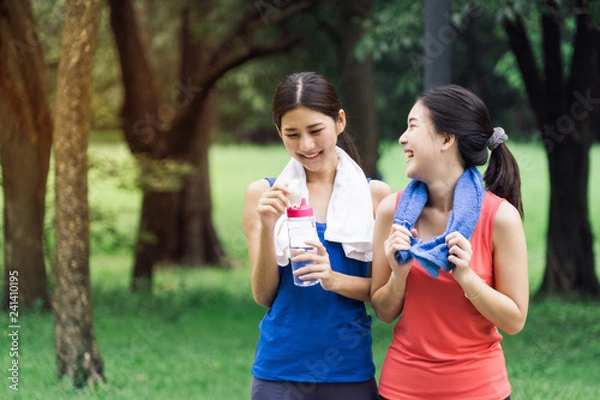 Obraz Couple of girl go exercise in a park and feeling friendly