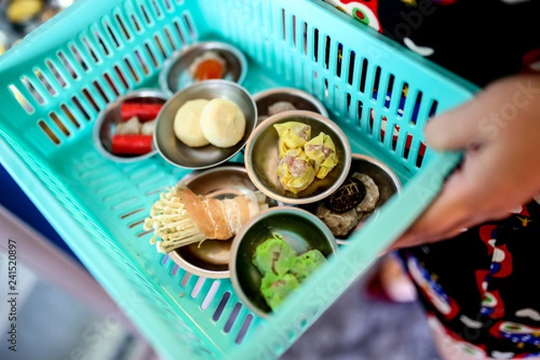 Fototapeta Dim sum in the basket, mixed dim sum in small stainless plate at street food stall in morning time.