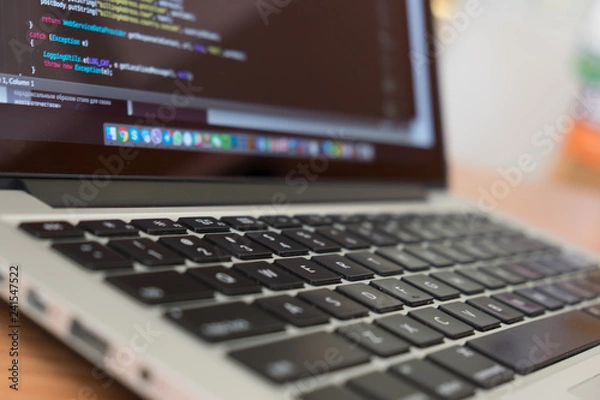 Fototapeta Developer notebook and  keyboard coding Java Script