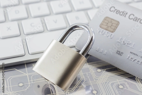 Obraz Padlock and credit card on keyboard and electronic circuits.