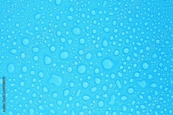 Obraz closeup drops water on blue background