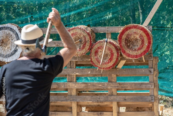 Obraz A man is ready for throwing axe on competition.