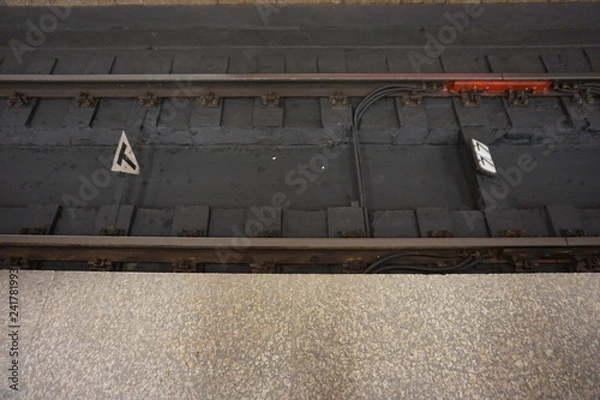 Fototapeta rails, sleepers and part of the platform at the station in the metro