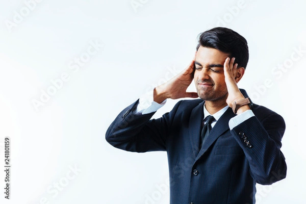 Obraz Portrait of a handsome businessman holding his head in disbelief, in pain or meditating,  isolated on white background.