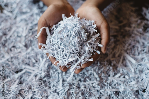 Fototapeta hand showing heap of shredded paper. Concept of recycle and office work of confidential