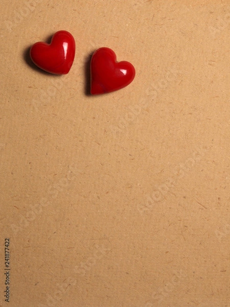 Obraz two red ceramic hearts on love letter paper background for Valentine's Day