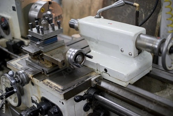 Fototapeta Lathe machine for metal cutting, machinery center background.
