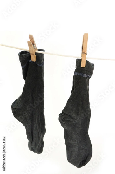 Fototapeta Worn socks drying on the string