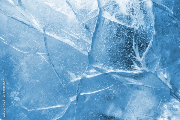 Fototapeta Abstract ice background. Blue background with cracks on the ice surface