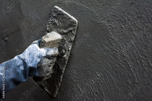 Obraz ręka pracownika budowniczego tynkowanie na ścianie