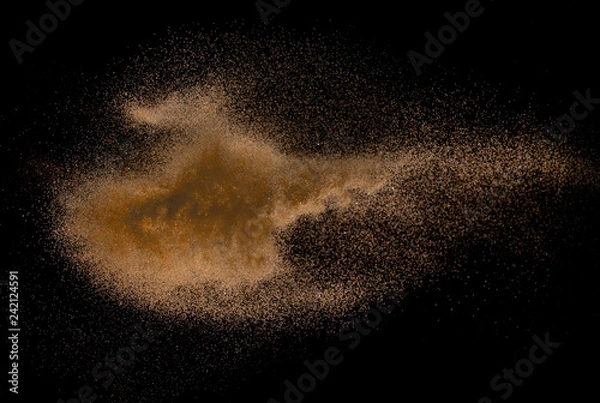 Fototapeta Sandy explosion isolated on over dark background,Abstract sand cloud,Motion blur