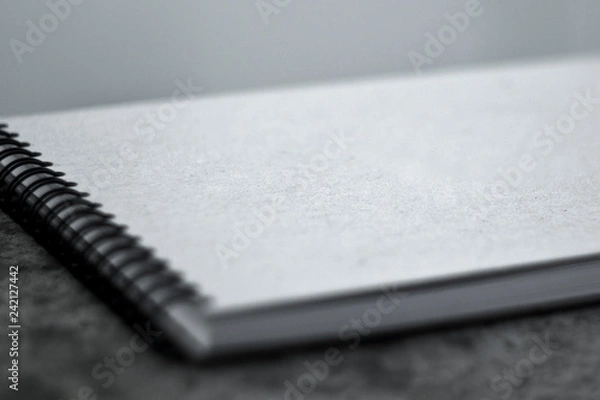 Obraz Sketchbook with a hard cardboard cover on the ground. Close-up.