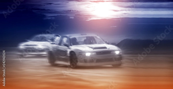 Fototapeta Blurred two drifting cars battle on speed track, sport concept