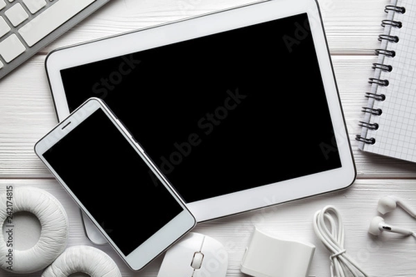 Fototapeta White modern digital tablet and smartphone, headphones, computer mouse and keyborad on white background