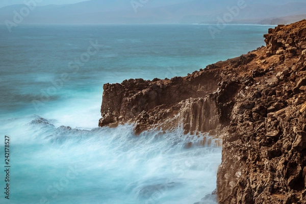 Fototapeta waves long exposure hitting coast