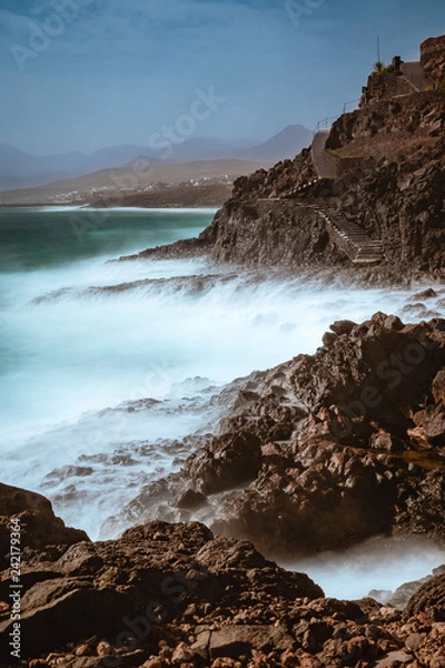Fototapeta waves long exposure hitting coast