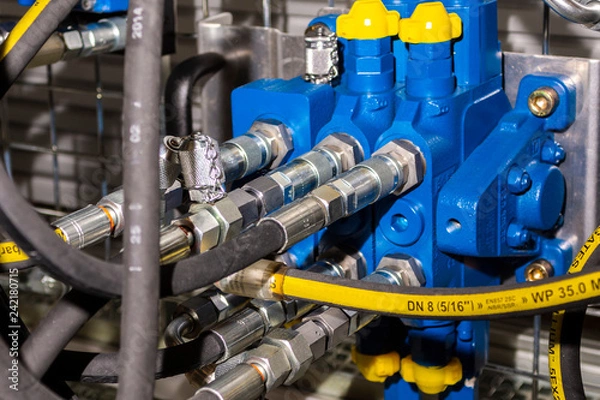 Fototapeta Close up of pipe system of hydraulic valves in agricultural machinery