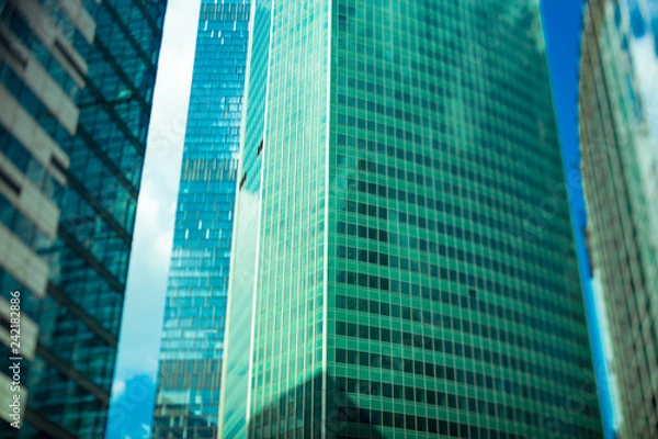 Fototapeta Abstract fragment of contemporary architecture, walls made of glass and concrete. Glass curtain wall of modern office building