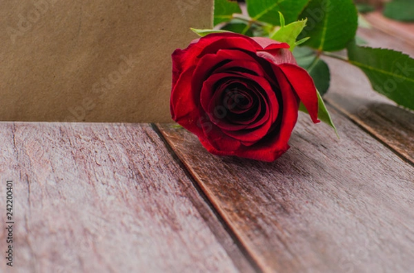 Fototapeta Red rose and Valentines day hearts on wood. Top view with copy space