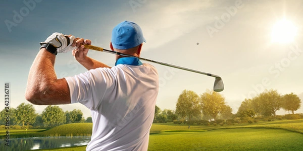 Obraz Male golf player on professional golf course. Golfer with golf club taking a shot